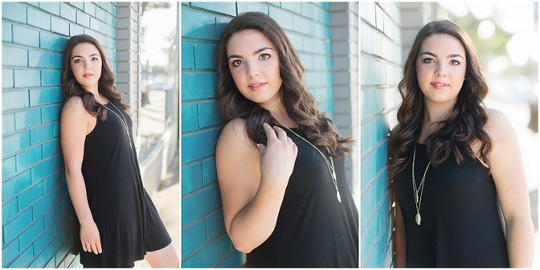 senior leaning against blue wall 